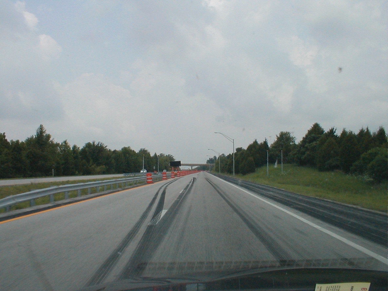 Heaeding east near the former toll booths at the western terminus. This poles mark the former location of signs annoucing the upcoming toll.