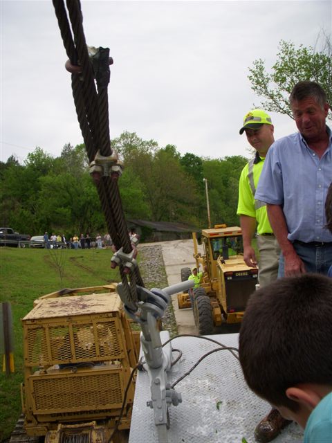 Shawn Massingille, KYTC foreman for Monroe County, and Joe Stephens react as the Sloan is christened with a bottle of champagne.