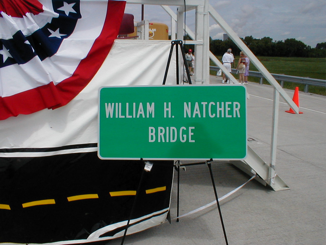 A decorative "William H. Natcher Bridge" sign on display at the ceremony's stage.